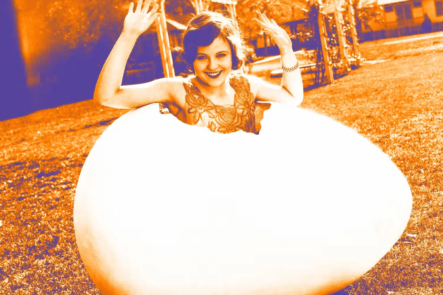 Woman sitting in giant egg