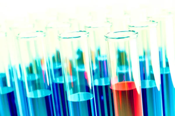 Scientific beakers with red and blue liquids