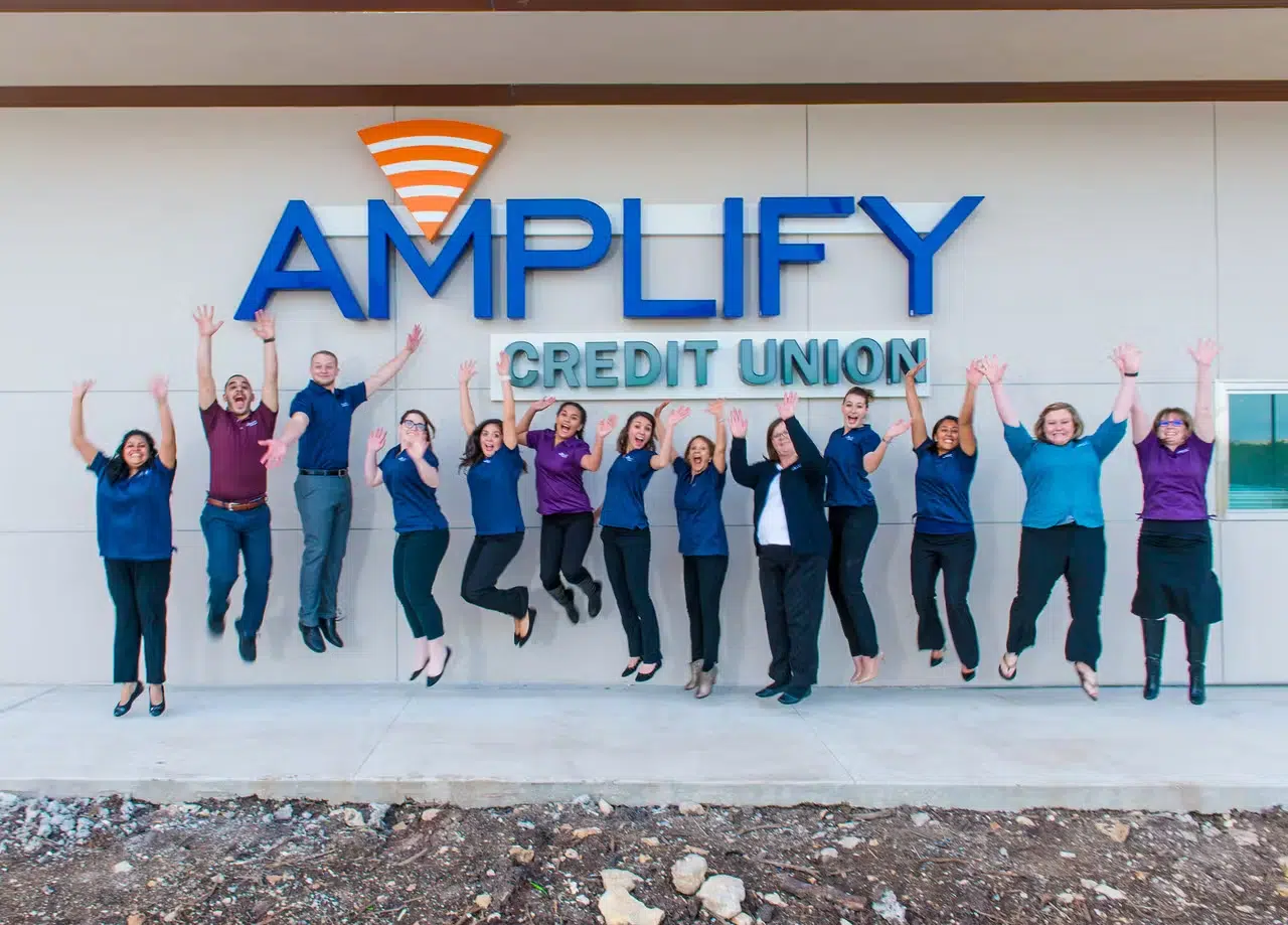 Amplify employees jumping in the air