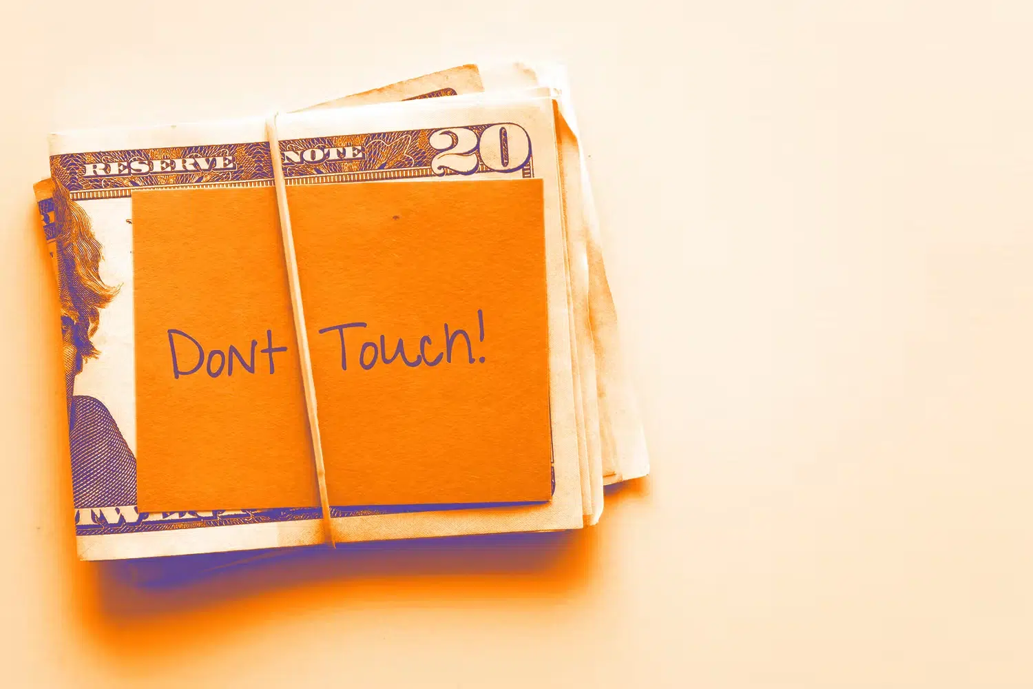 Money in rubber band with note reading "don't touch"