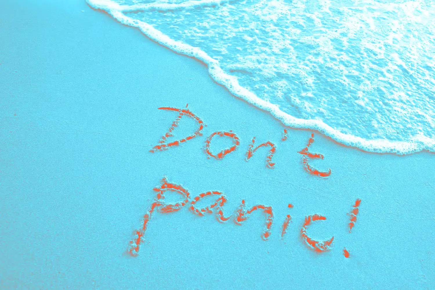Spelling in sand "Don't panic"